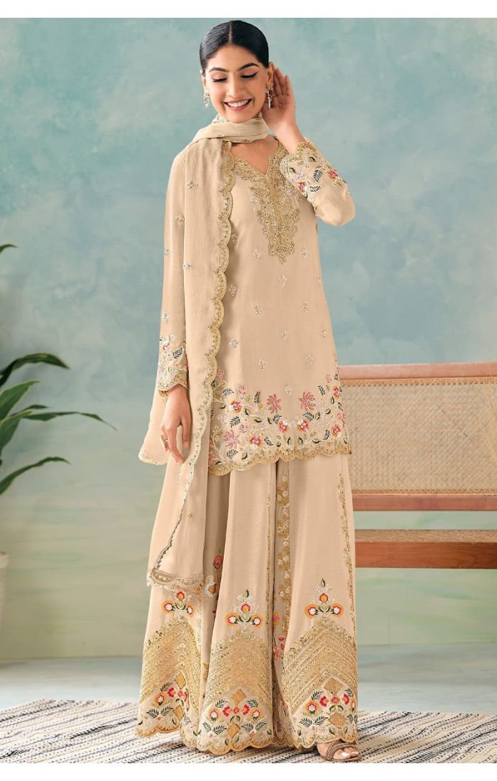  Front view of cream chinon salwar suit with heavy embroidery and sequins work paired with a matching dupatta.