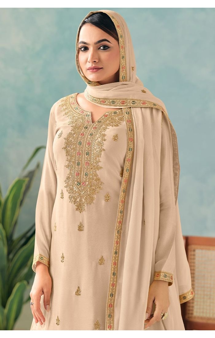 Close-up showcasing intricate heavy thread embroidery and sequin details on cream chinon fabric.