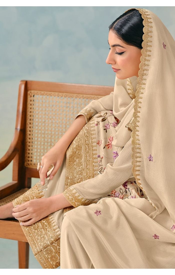 Close-up of neckline and detailed thread embroidery on cream chinon fabric