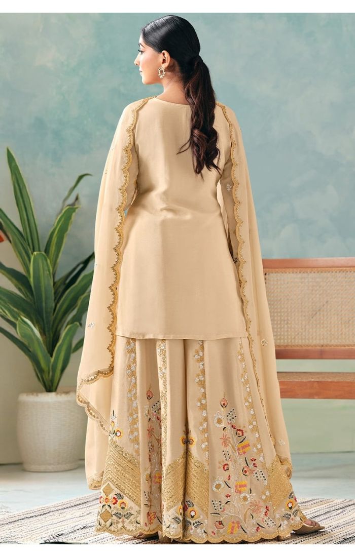 back view of neckline showing intricate thread embroidery and sequin detailing on cream chinon fabric.