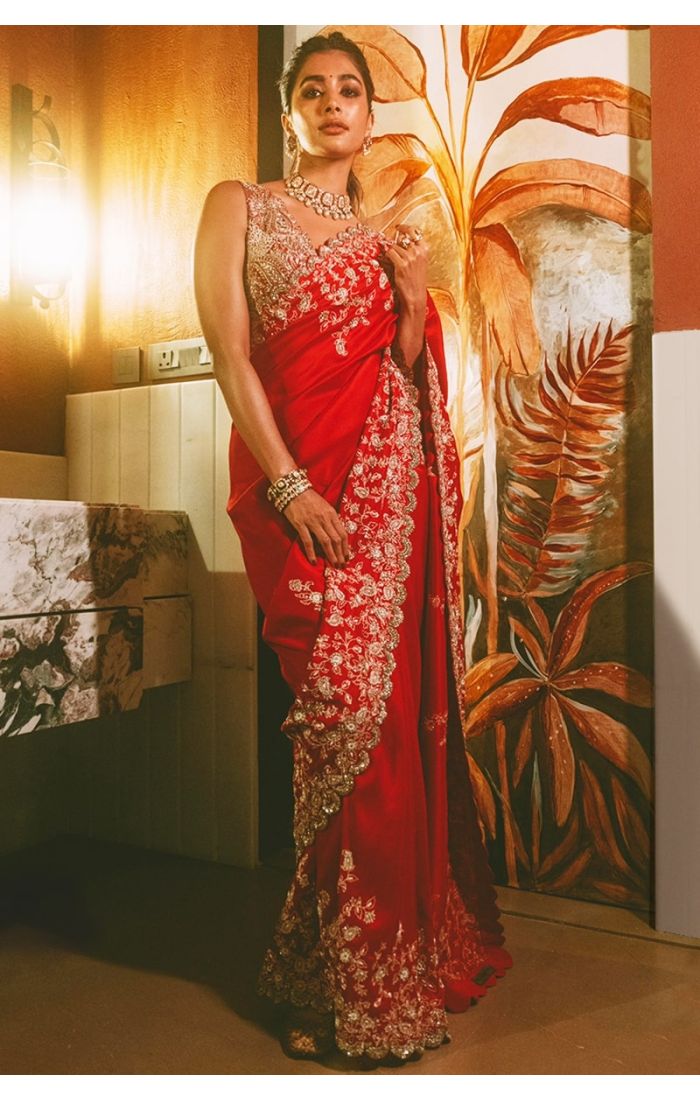 Front pose of model wearing crimson red bridal silk saree with embroidered blouse