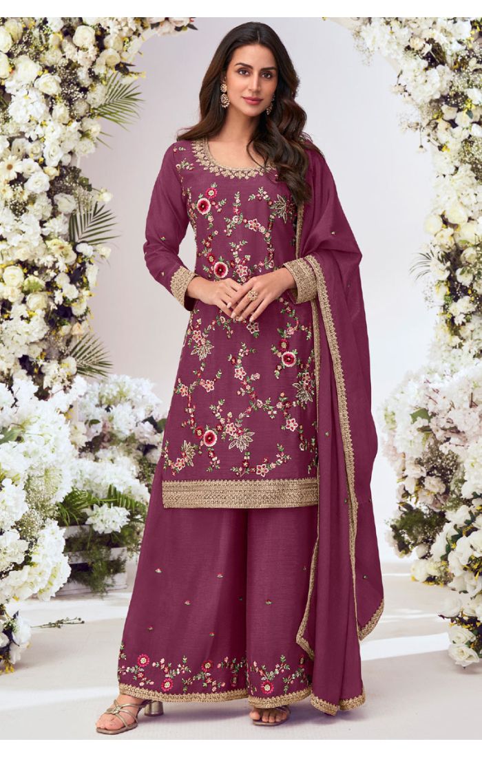 Close-up of wine embroidered viscose suit with floral thread and zari work