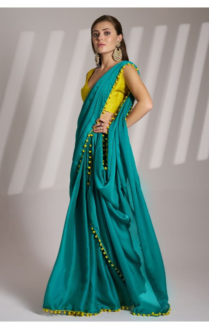 Emerald Green Chiffon Saree with Mustard Yellow Blouse and Pom-Pom Detailing – Perfect for Weddings and Festive Occasions