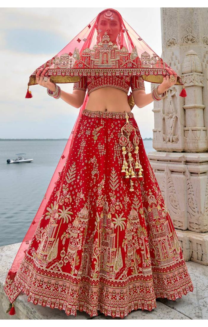 Exquisite red bridal lehenga with Zardosi embroidery and architectural design, ideal for weddings and special occasions. Germany, Poland and Norway