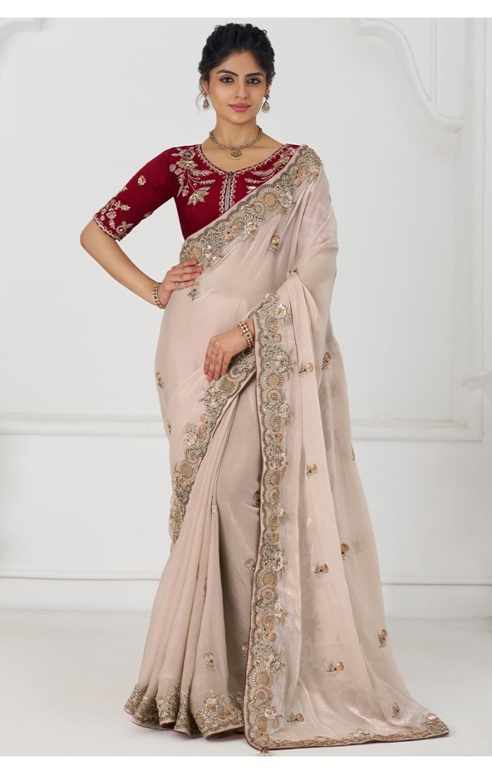 Woman wearing chiku Fendi silk saree with maroon blouse front view – full-length