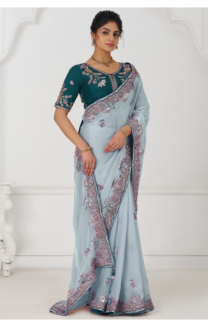Front pose of model in graceful grey Fendi silk saree with zari and sequin embroidery, styled with emerald blouse.