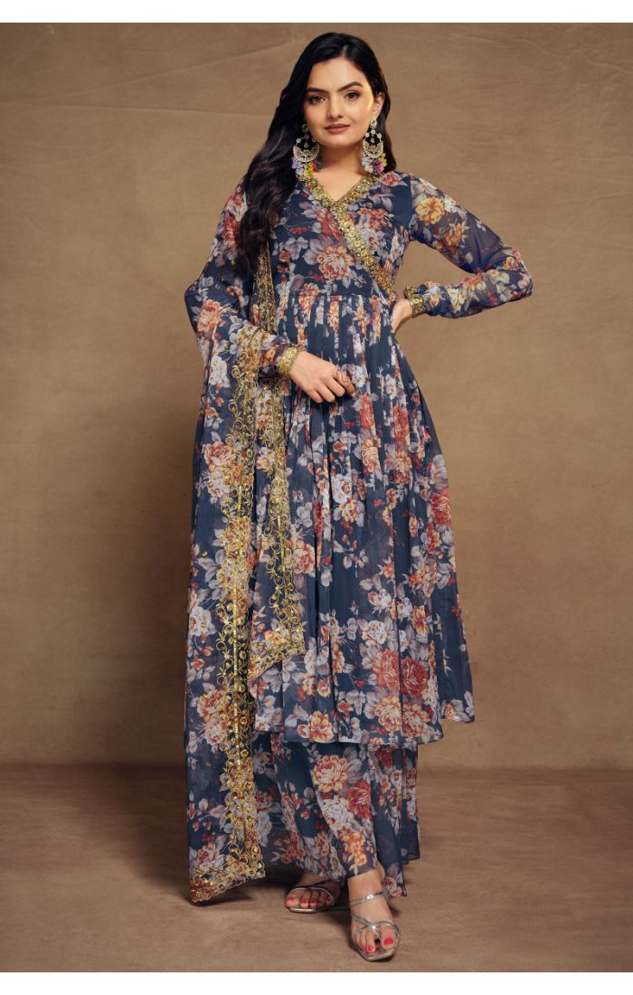 Woman wearing a flowy georgette blue floral ethnic set with V-neck and embroidered dupatta.