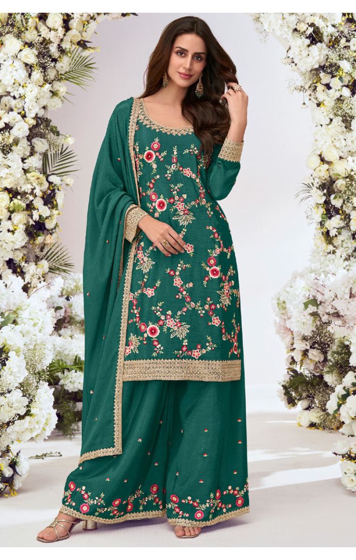 Model wearing a green georgette floral embroidered suit with scoop neck, palazzo pants, and matching dupatta with golden lace border.