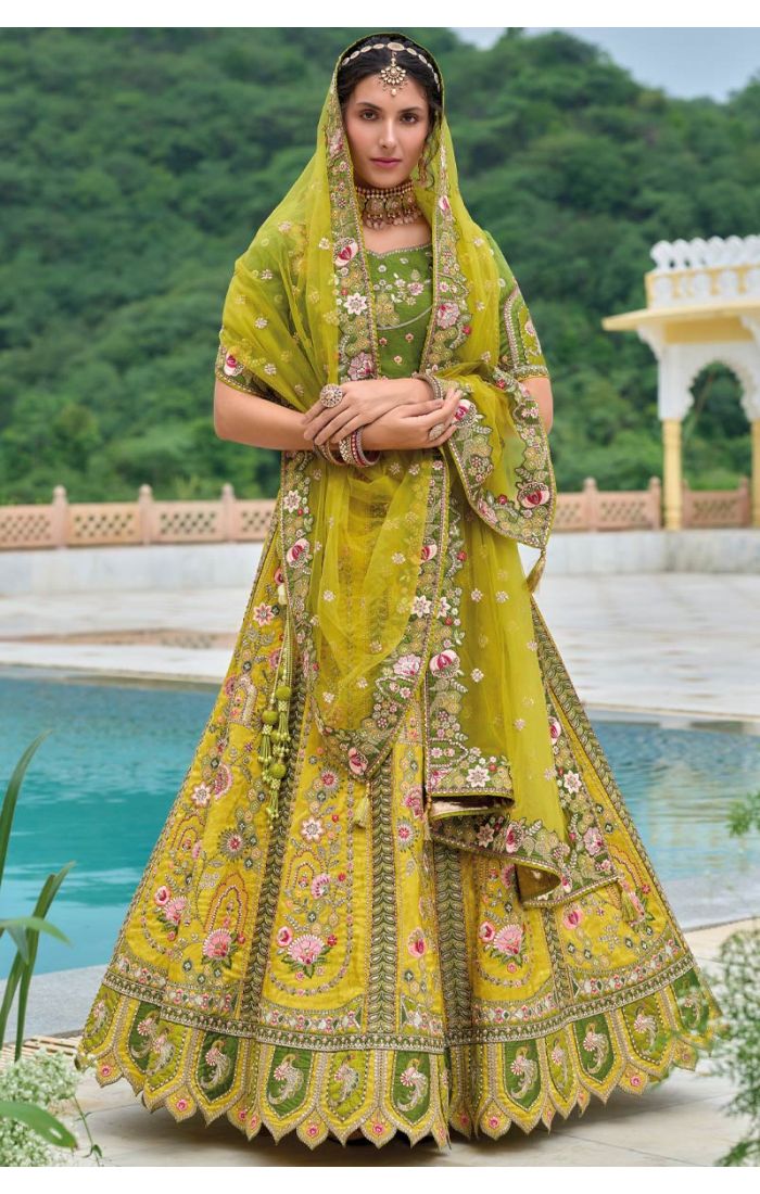 Model wearing a green floral embroidered lehenga choli, styled with traditional jewelry and light makeup, perfect for Haldi and festive occasions.