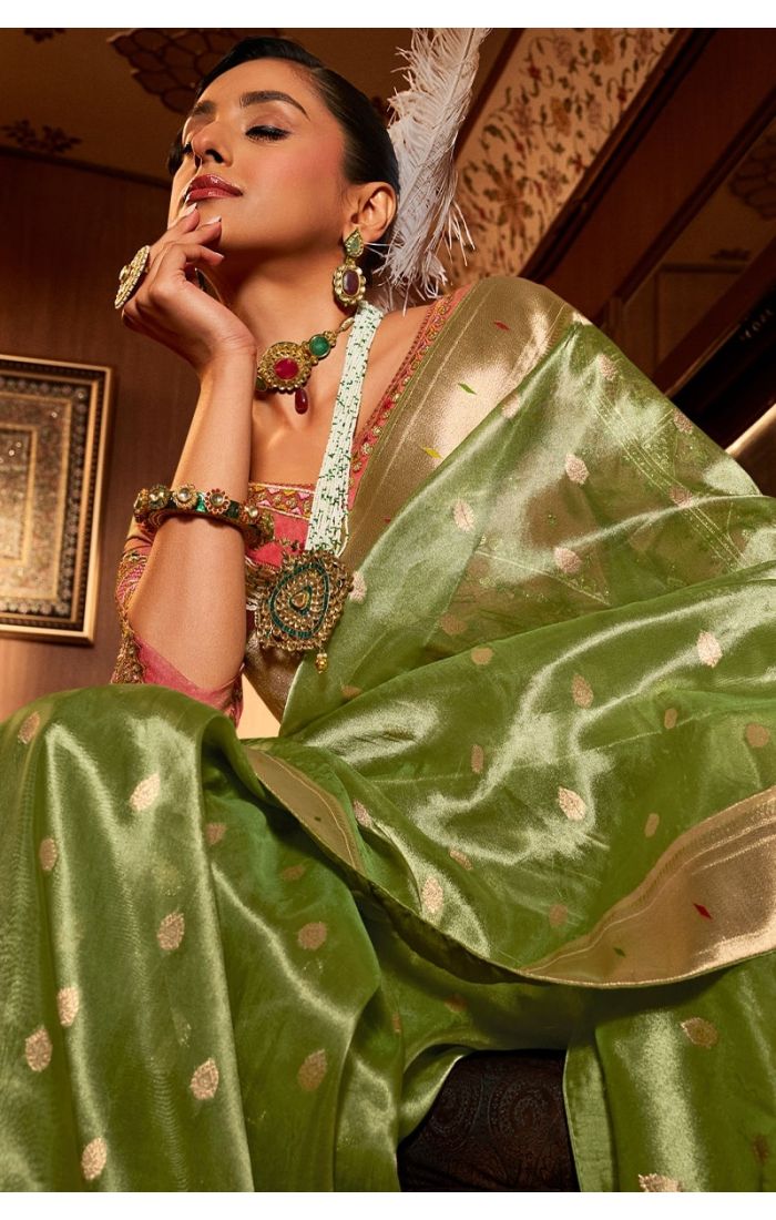 Close-up of resham and stone work on green tissue silk saree