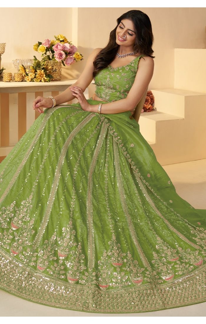 Bridal green net lehenga showcasing wide flare and intricate detailing