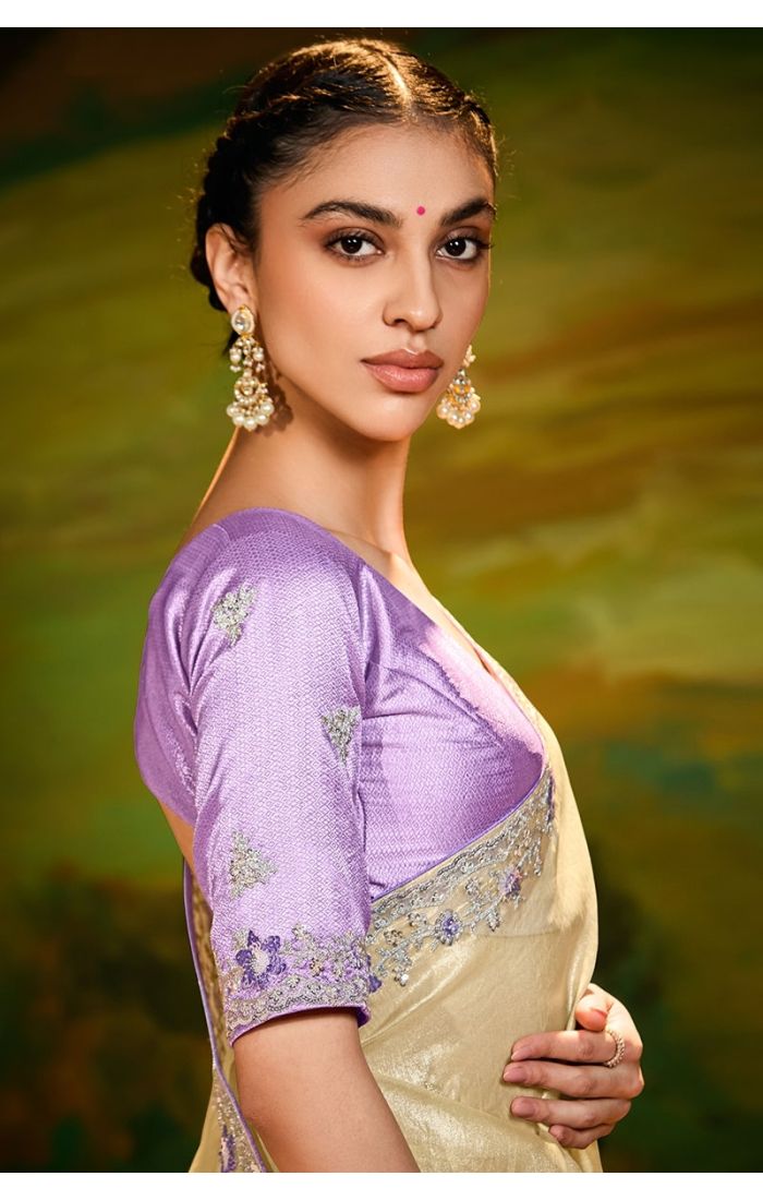 Side drape showcasing embroidery details of cream organza saree with lavender blouse