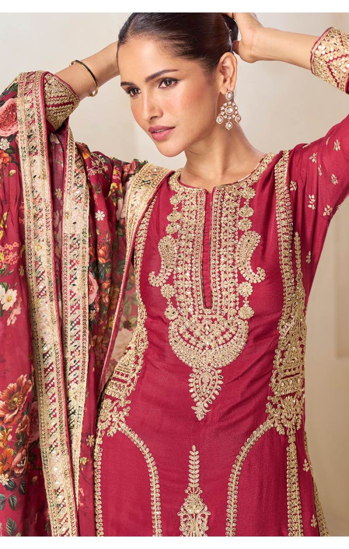 Close-up of the model in maroon ethnic suit featuring intricate golden embroidery on neckline and sleeves, paired with floral printed dupatta.