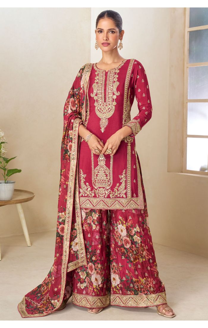 Model wearing a maroon embroidered ethnic suit with floral printed palazzo and dupatta, showcasing front design in a minimal beige background.