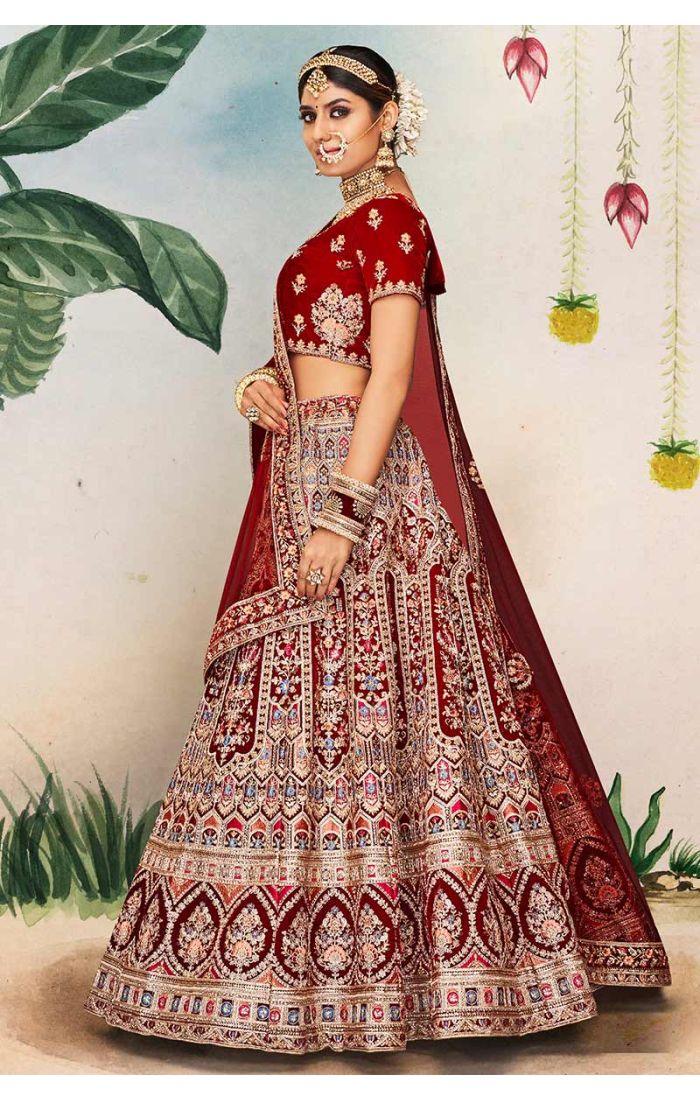 Detailed shot of maroon scoop neck blouse and embroidered dupatta with heavy floral and temple designs, premium bridal outfit.