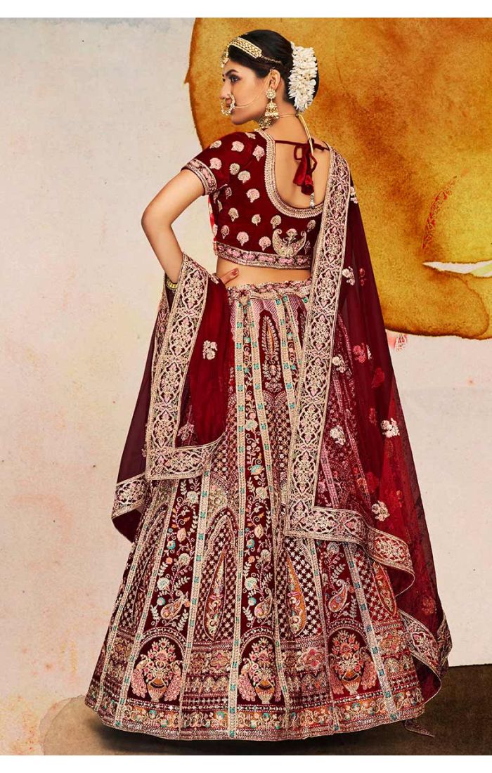 Flared skirt and border design of maroon velvet bridal lehenga with intricate paisley embroidery, traditional luxury bridal wear.