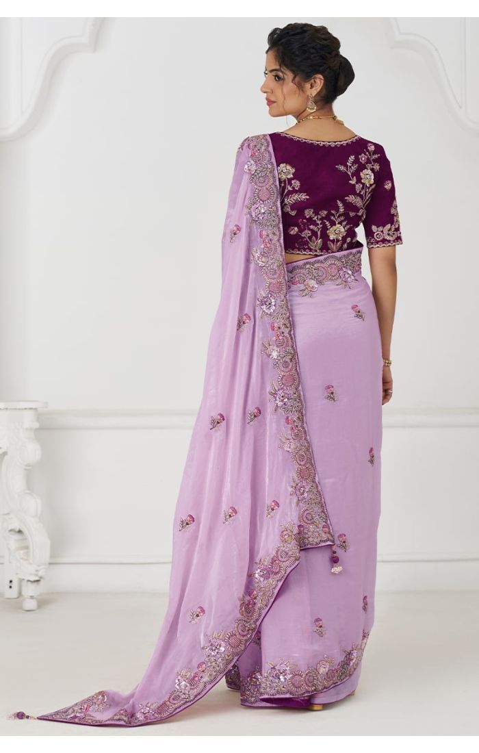 Back view highlighting wine contrast blouse and detailed zari embroidery on mauve saree pallu.
