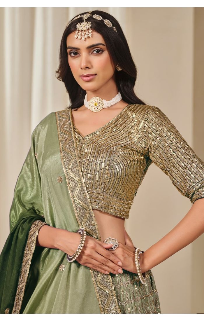 Close-up of blouse embroidery and neckline in green mehendi lehenga set