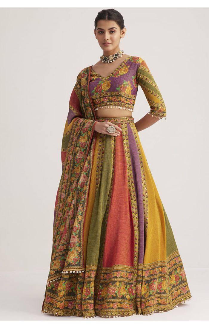 Model wearing multi-color silk Navaratri lehenga choli with floral print and V neck blouse, designer party wear chaniya choli