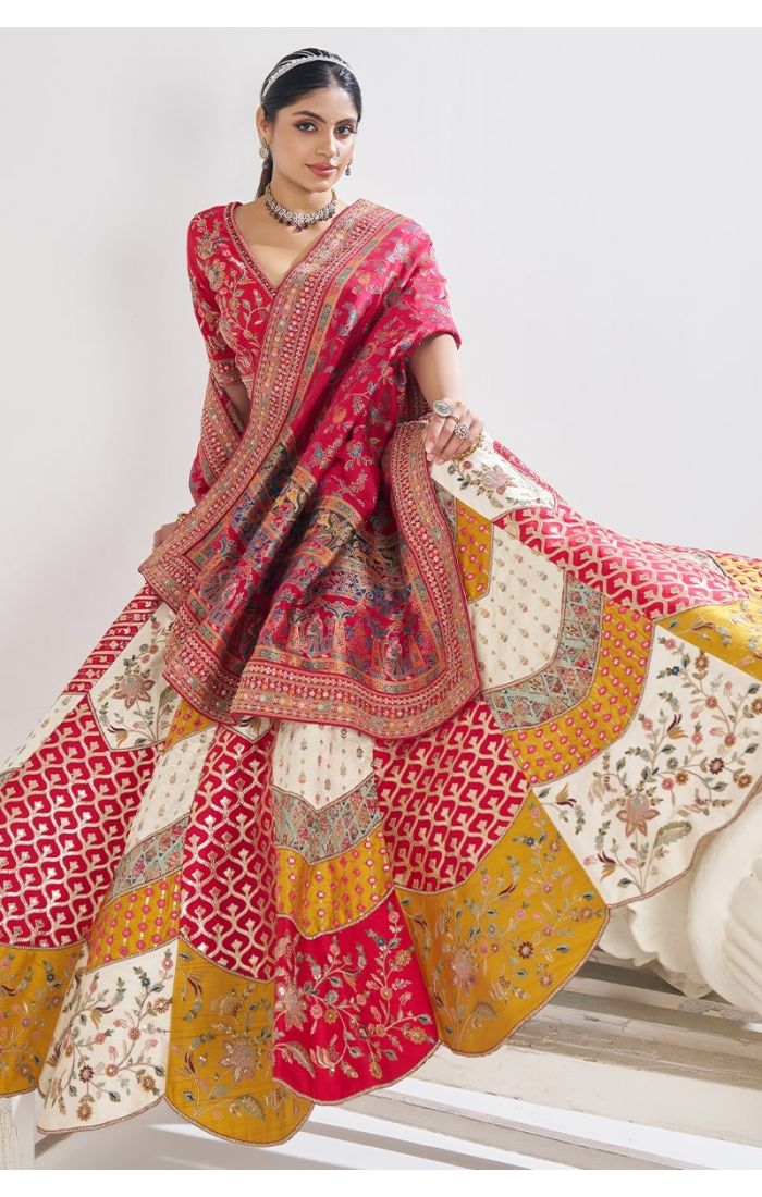 Bridal portrait showcasing full flare of designer multicolor scallop lehenga with traditional dupatta