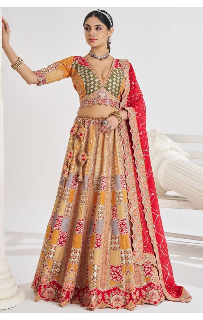 Front pose of designer mustard lehenga with multi-tone embroidery and deep neck blouse