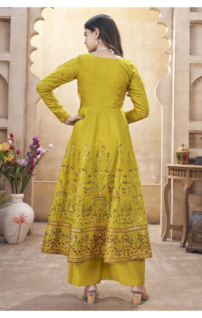 Mustard yellow embroidered palazzo suit with mirror work and tassel dupatta – perfect for weddings and festive occasions.