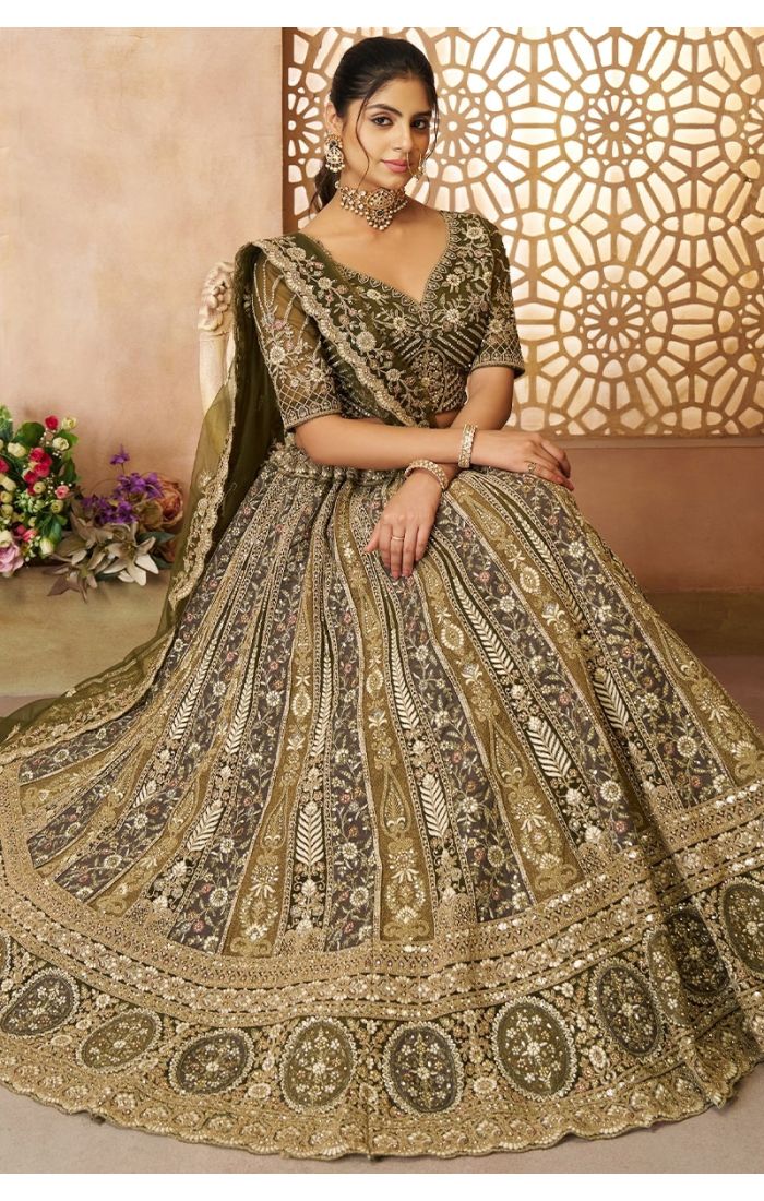 Bride seated wearing soft net embroidered bridal lehenga in olive color