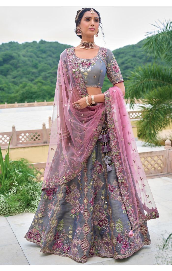 Pastel grey and pink embroidered lehenga choli with intricate floral detailing for weddings.