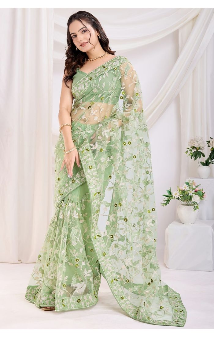 Festive pista green net saree with Banglori blouse and intricate threadwork embroidery.