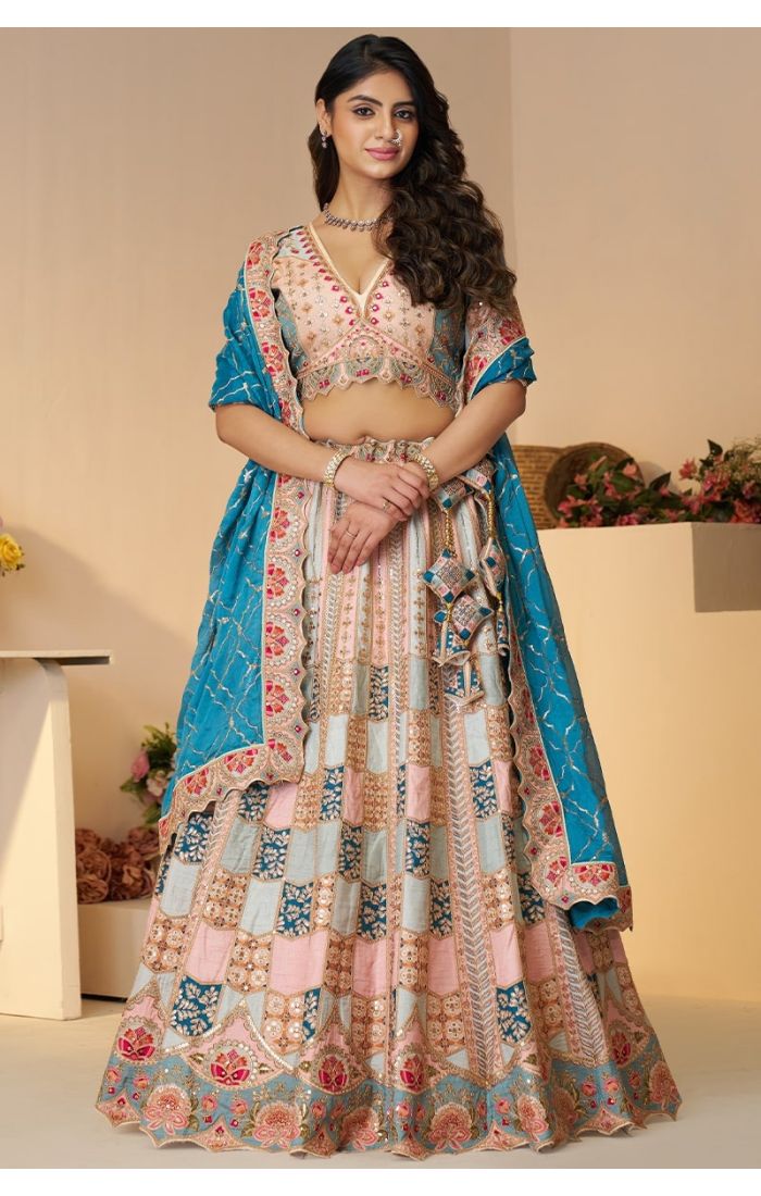 Full front standing view of designer soft net lehenga in powder blue with zari and sequin work