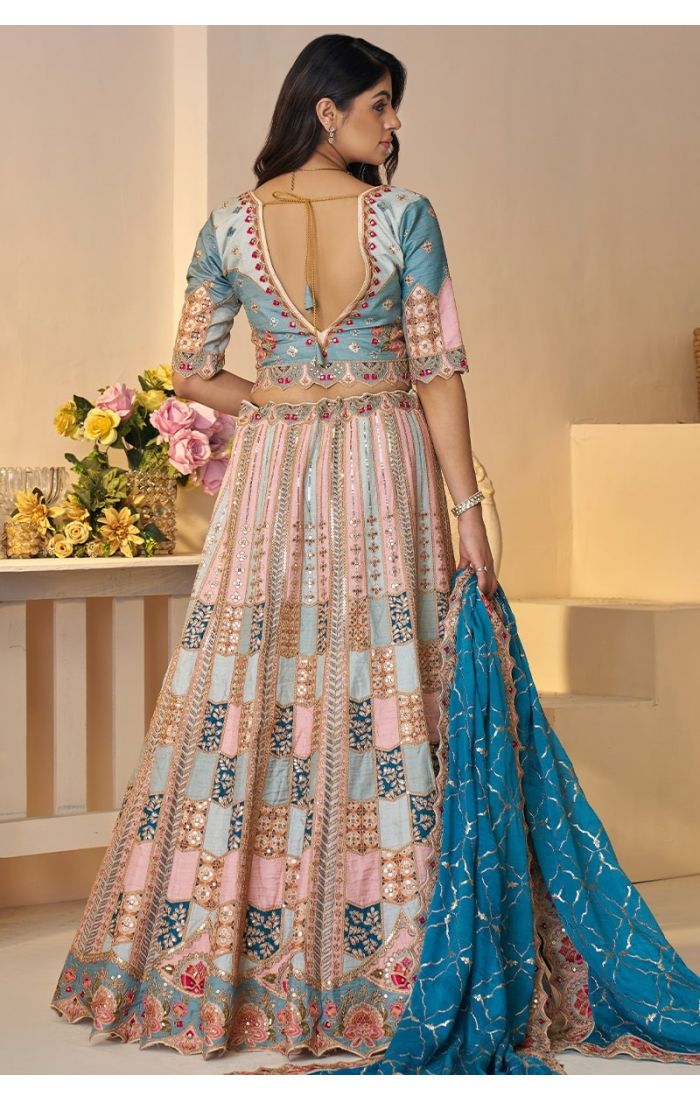 Back view showing blouse cut and flared lehenga panels with jaal and sequin detailing