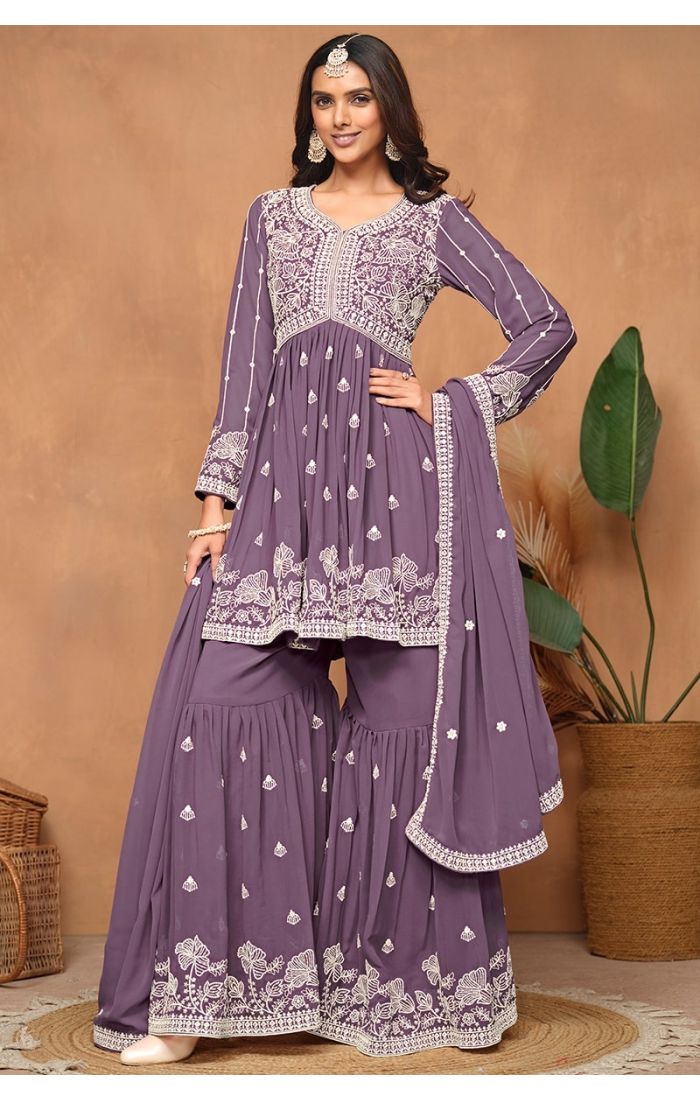 Front view of purple faux georgette sharara suit with heavy embroidery and sequins.