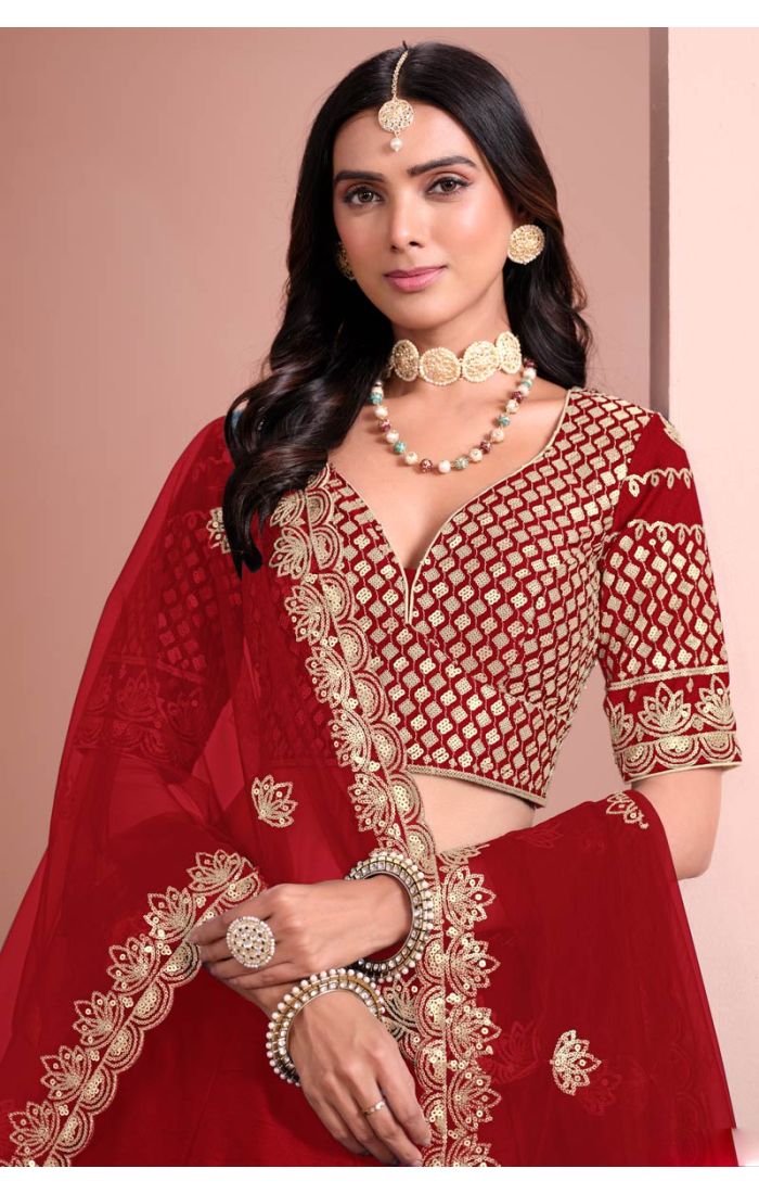 Red bridal lehenga choli with golden embroidery and net dupatta for wedding and festive occasions.