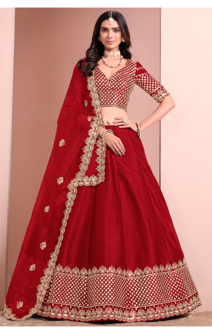 Red bridal lehenga choli with golden embroidery and net dupatta for wedding and festive occasions.