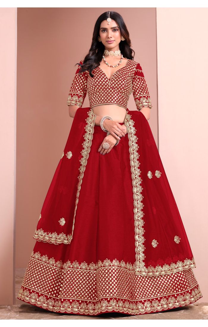 Red bridal lehenga choli with golden embroidery and net dupatta for wedding and festive occasions.