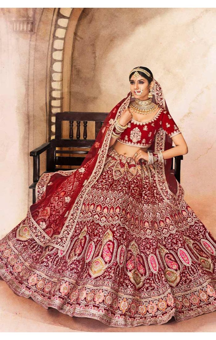Detailed shot of red scoop neck blouse and embroidered dupatta with ornate border work, premium bridal ensemble.