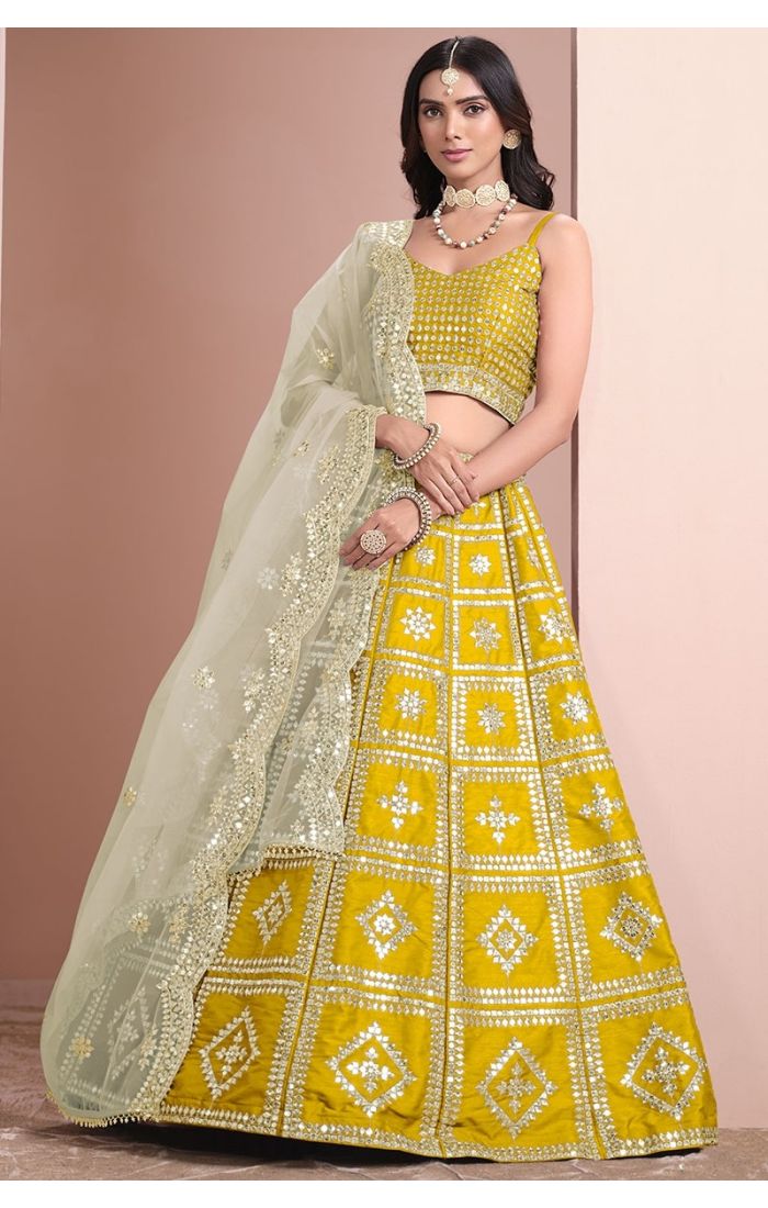Regal Yellow Mirror Work Lehenga Choli with sleeveless blouse and net dupatta, perfect for weddings and festive occasions