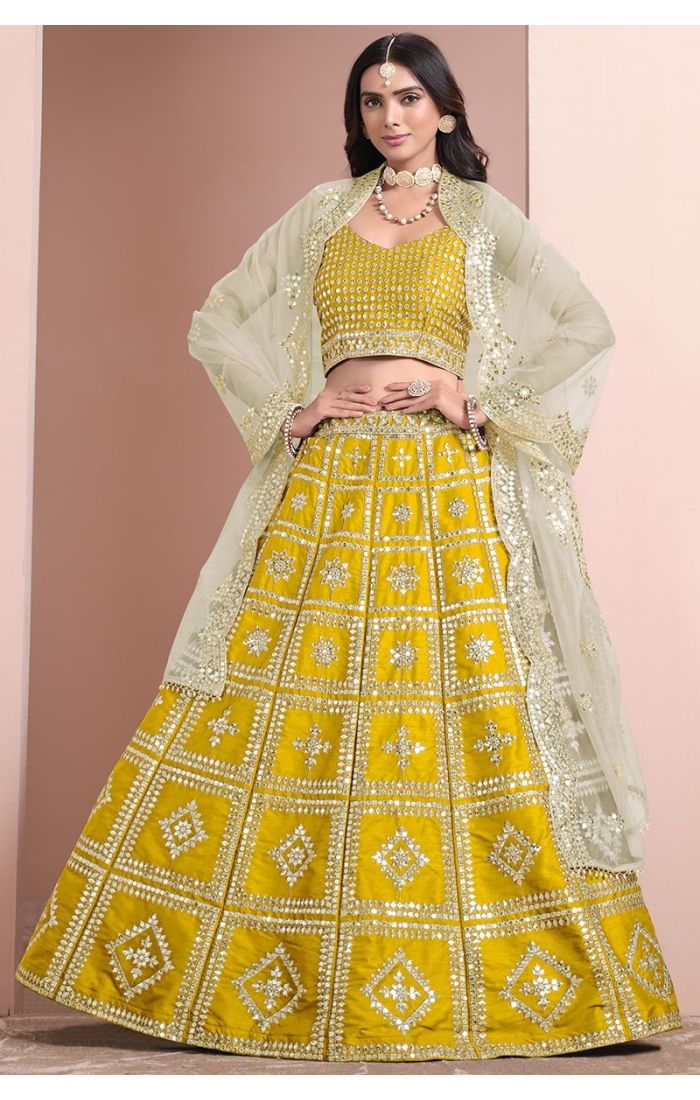 Regal Yellow Mirror Work Lehenga Choli with sleeveless blouse and net dupatta, perfect for weddings and festive occasions