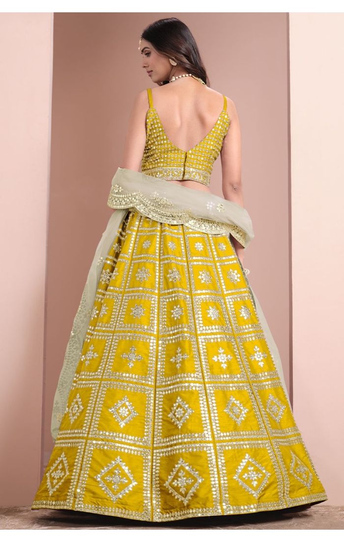 Regal Yellow Mirror Work Lehenga Choli with sleeveless blouse and net dupatta, perfect for weddings and festive occasions