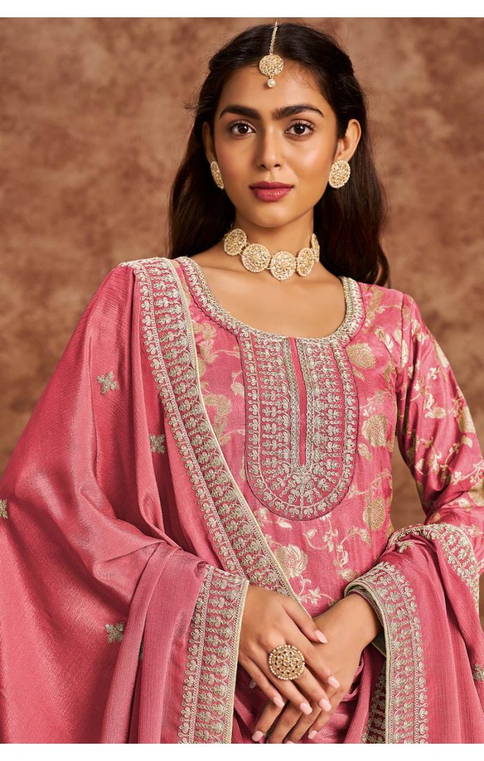 Close-up of neckline and dupatta of rose pink embroidered salwar kameez, showcasing detailed stone and lace work.