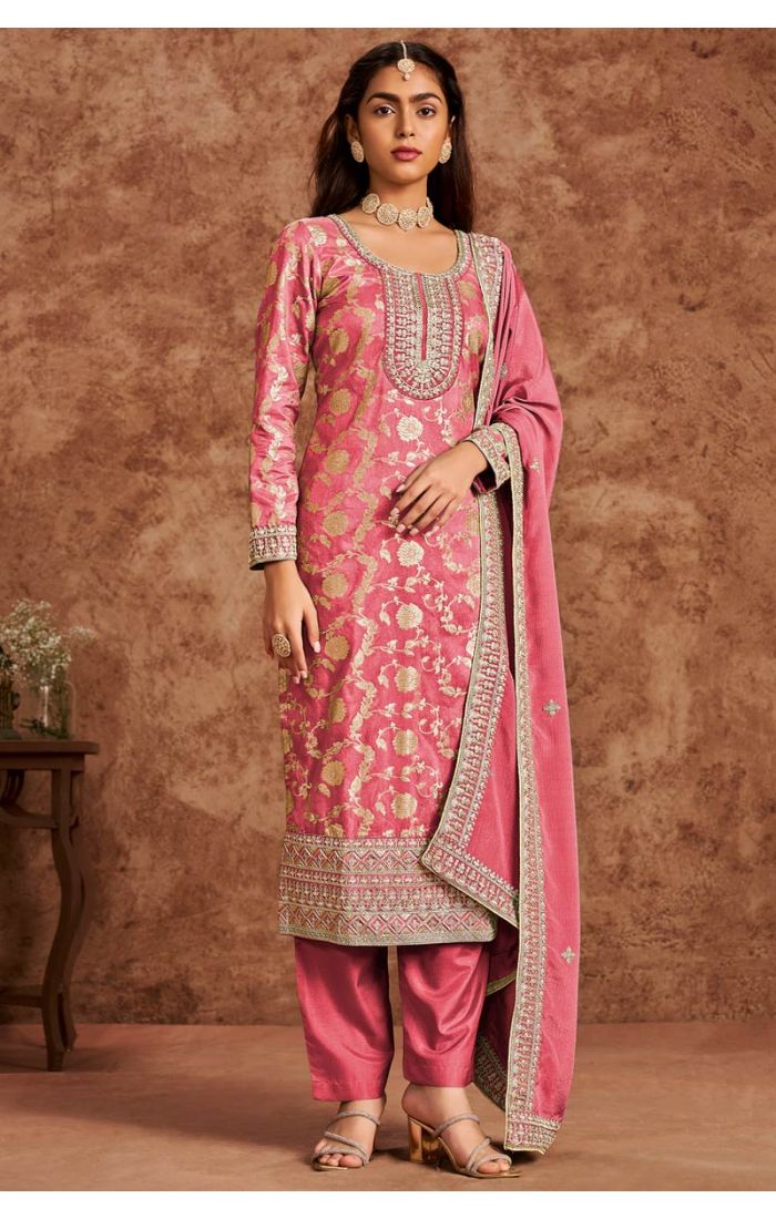 Front view of rose pink crush silk straight salwar suit with heavy zari and resham embroidery, styled for weddings and festivals.