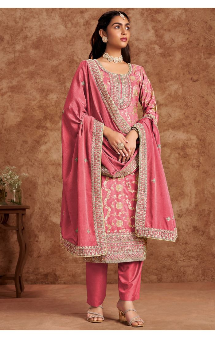 Front view of rose pink crush silk straight salwar suit with heavy zari and resham embroidery, styled for weddings and festivals.