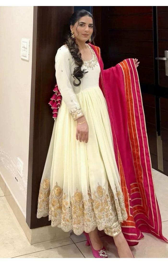 Elegant white georgette gown suit with golden embroidery and pink dupatta – perfect for weddings, parties, and festive occasions.