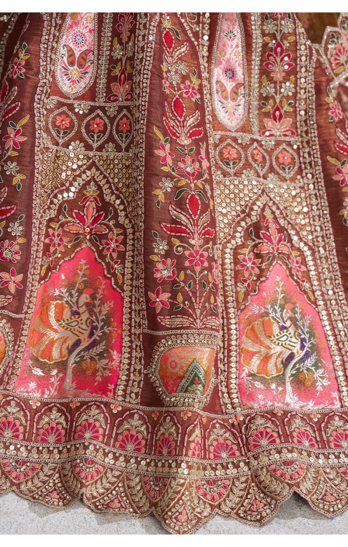 Close-up of intricate aari embroidery and bird motifs on mocha color bridal lehenga with sequins and patchwork