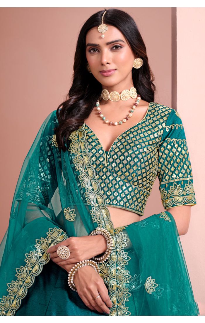 Close-up of teal green designer lehenga choli blouse with intricate zari and sequin work — Appelle Fashion