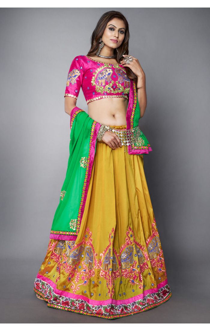 Full view of multicolor Navratri lehenga choli with yellow flared skirt, pink blouse, and green dupatta, festive folk wear.