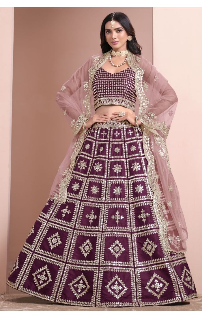 Wine-colored mirror work silk lehenga choli with net dupatta – perfect for weddings and festive occasions.